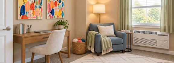 A bedroom with a bed, desk, and chair.