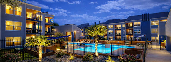 A small island with a tree in the middle of a pond at Infinity on the Landing Apartments, Euless 76040