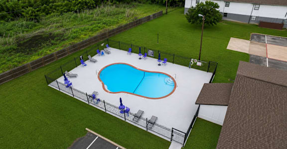 A small pool surrounded by a fence.