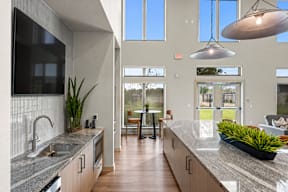 A modern kitchen with a large island and a dining area.