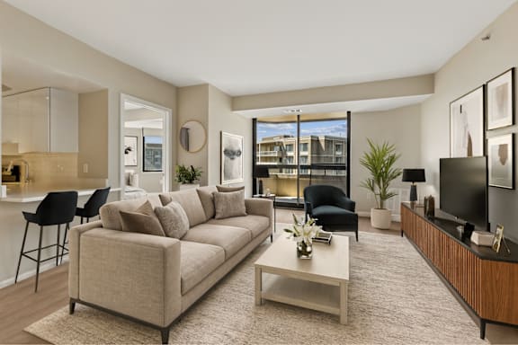 A living room with a couch, chairs, and a coffee table.