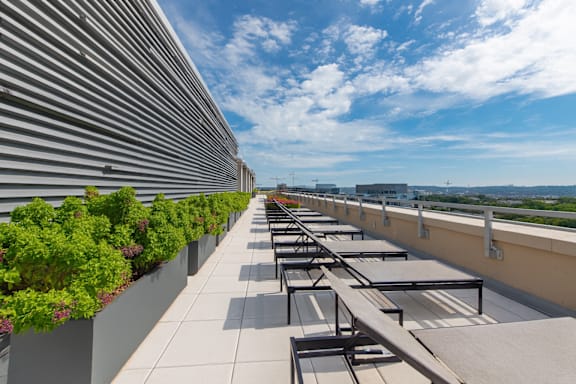 A rooftop with sun loungers and a metal wall at Artline Apartments, Washington, DC, 20024