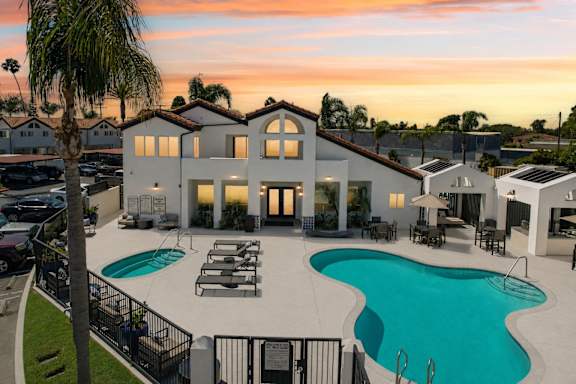 A large house with a pool in front of it.