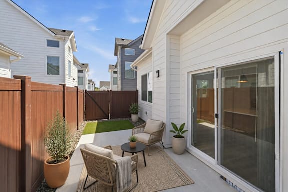 A white house with a patio furniture set at Alante Homes at Spring Run, Idaho