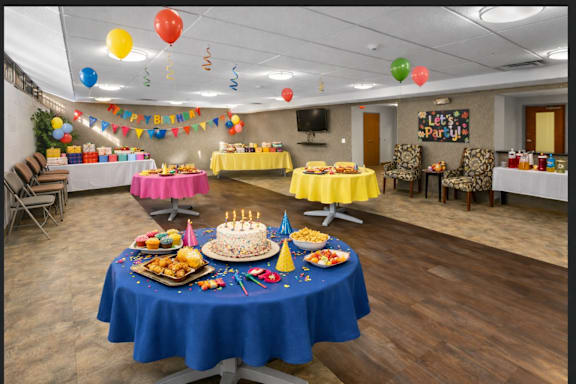 A birthday party with a cake and balloons.