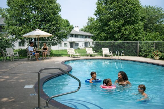 A group of people are enjoying a swim in a pool.