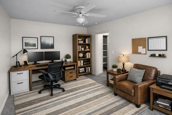 A room with a desk, chair, and bookshelf.