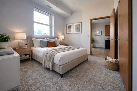 A bedroom with a large bed and a window.