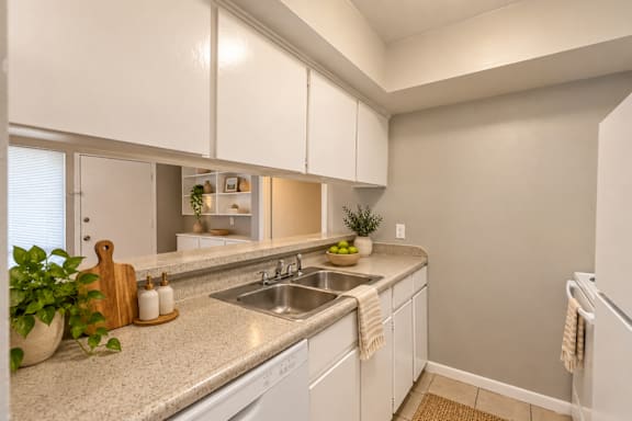 A kitchen with white cabinets and a granite countertop at Lifestyle at Shreveport in Shreveport, LA, 71109.
