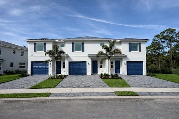 A white house with a blue garage door.