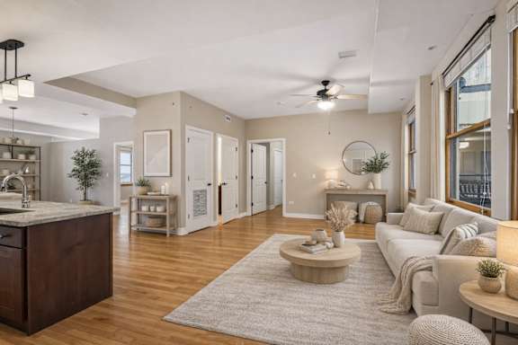 A modern living room with a kitchen area in the background.