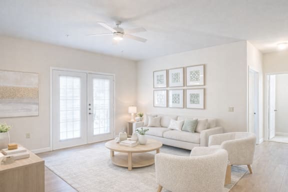 a living room with a kitchen in the background at The Madison Apartment Homes in Tyler, Texas