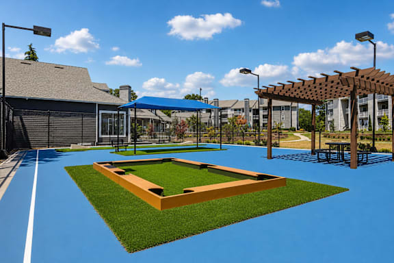 A park with a baseball diamond and a blue track.