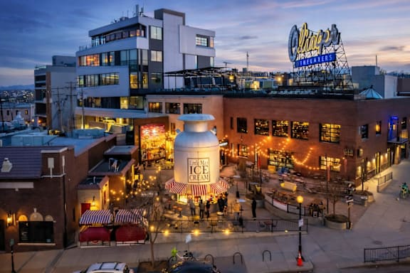 A large white cylindrical structure with the words "MAMA'S ICE CREAM" written on it is the focal point of the image.