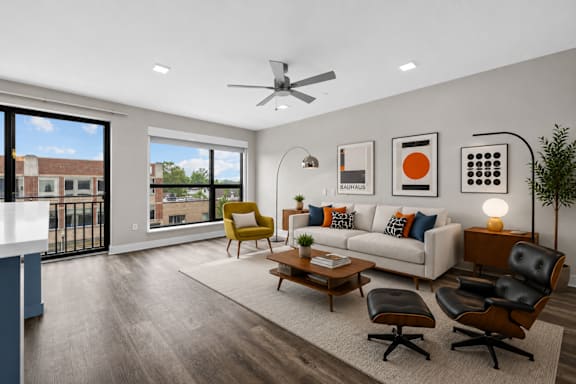 A modern living room with a yellow chair and a white couch.
