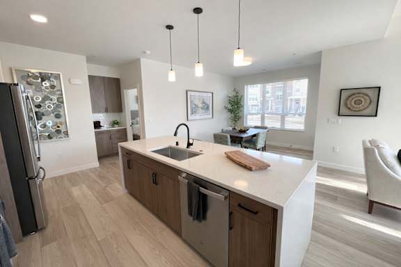 A modern kitchen with wooden cabinets and a white island.