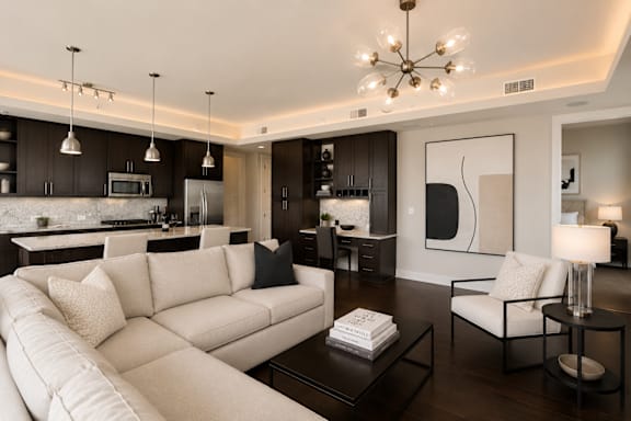 A modern living room with a white sofa and a coffee table.
