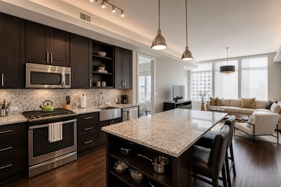 A modern kitchen with dark wood cabinets and a granite countertop.
