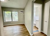 Thumbnail 3 of 5 - an empty bedroom with a bathroom in the background at Lakeside @ Biscayne Gardens,North Miami, FL,33181