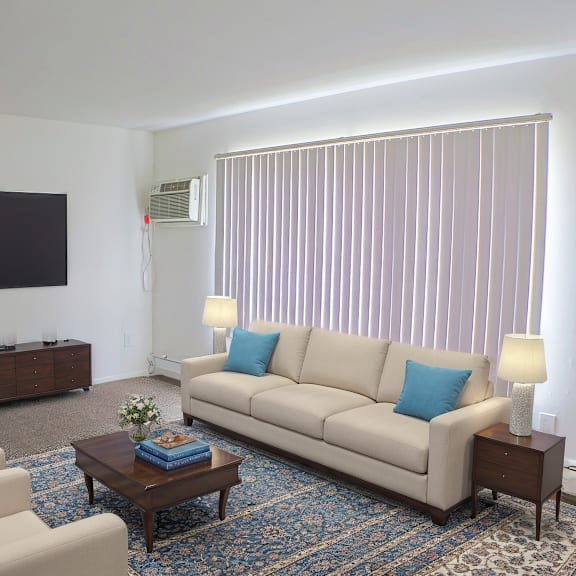 A living room with a couch, chairs, and a coffee table.