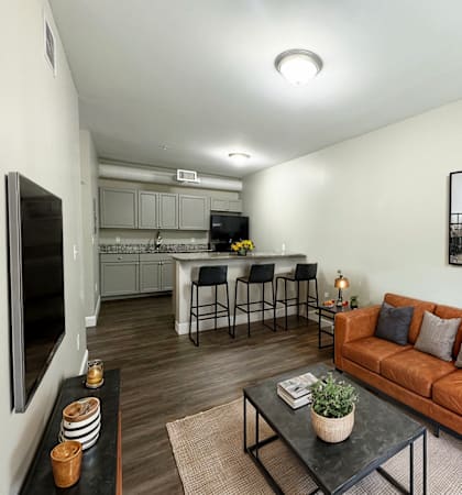a living room with a couch and a kitchen