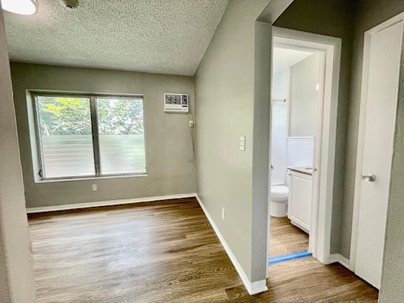 an empty bedroom with a bathroom in the background at Lakeside @ Biscayne Gardens,North Miami, FL,33181