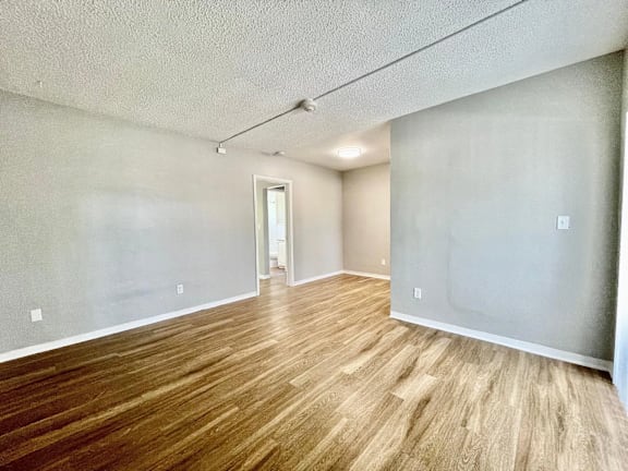 an empty living room with a hardwood floor at Lakeside @ Biscayne Gardens,North Miami, FL,33181