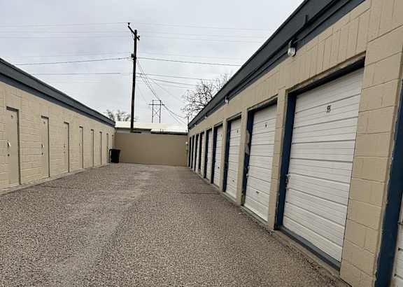 A long row of garage doors are closed.