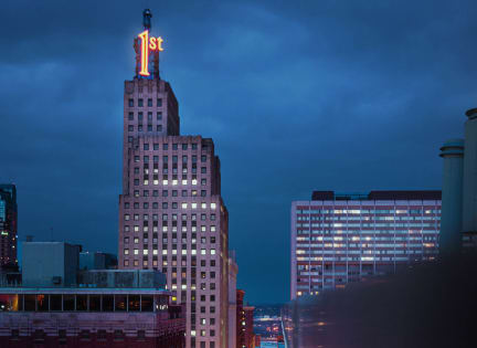 a cityscape at night with a train track in the foreground