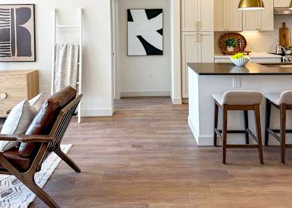A kitchen with a bar and chairs.
