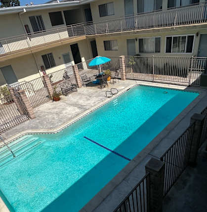 A small pool with a fence around it.