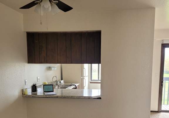 a dining room and kitchen with a table and chairs