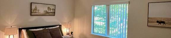 a large bedroom with a bed and a window  at Mullan Reserve Apartments, Montana