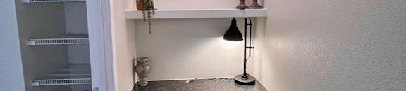 a small desk with a chair in a room with a closet  at Mullan Reserve Apartments, Montana
