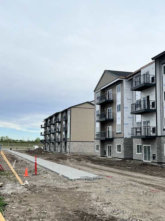 a building is being constructed next to a dirt road