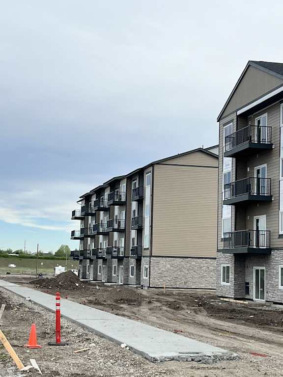 A construction site with a building in the background.