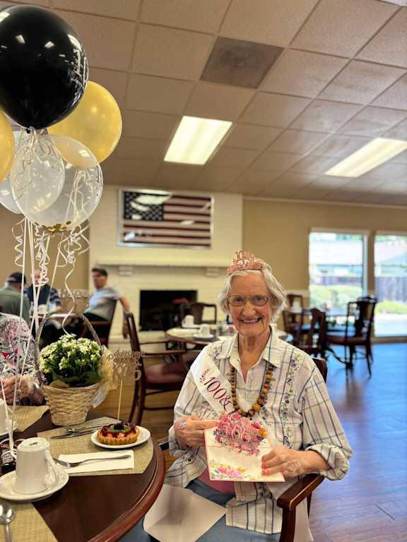 An elderly woman smiling at Lodi Commons Senior Living, California