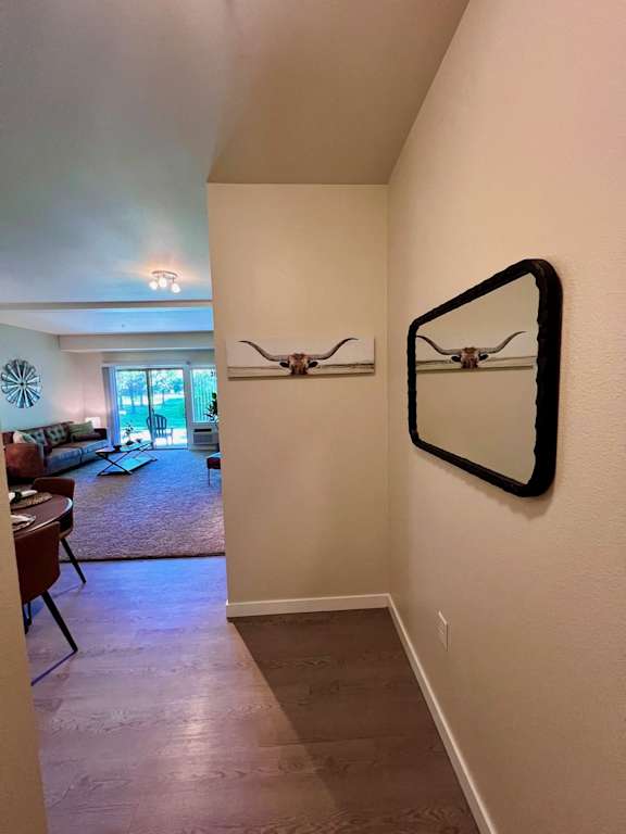 a view of the living room from the hallway with a mirror on the wall  at Mullan Reserve Apartments, Missoula, Montana