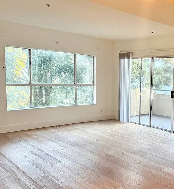 A room with a sliding glass door leading outside.