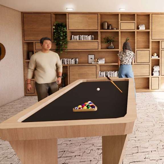 A man and woman are standing in a room with a pool table and shelves filled with books and plants.