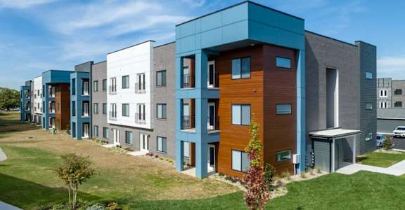 A row of modern townhouses with different colored exteriors.