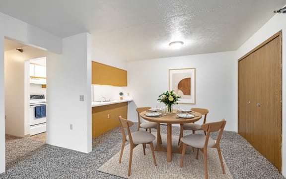 A dining room with a table set for two.