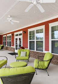 Two people reading book at The Lodge at Johns Road Apartments, Alabama