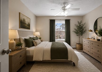 A bedroom with a bed, nightstands, and a ceiling fan.