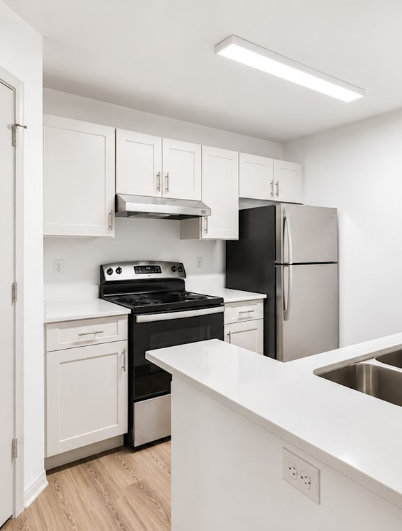 A modern kitchen with a stainless steel dishwasher and oven.