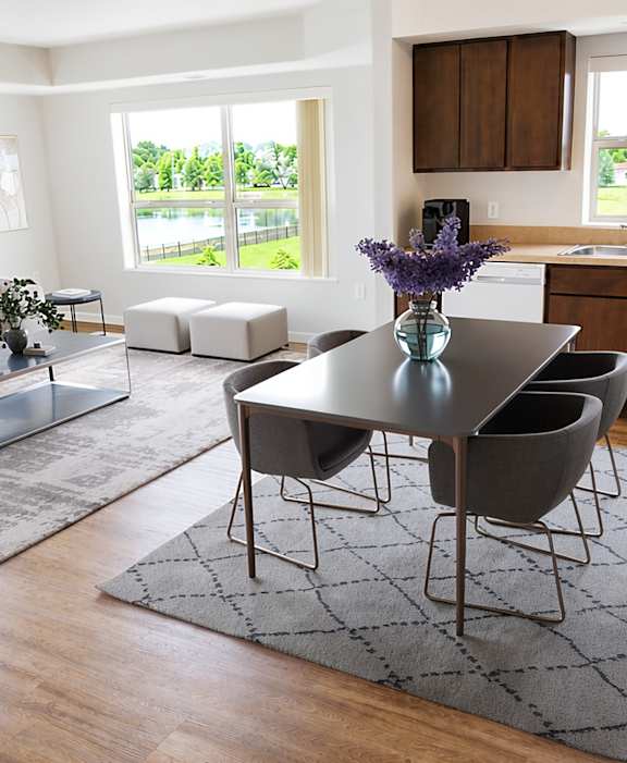 A modern dining room with a glass table and chairs.