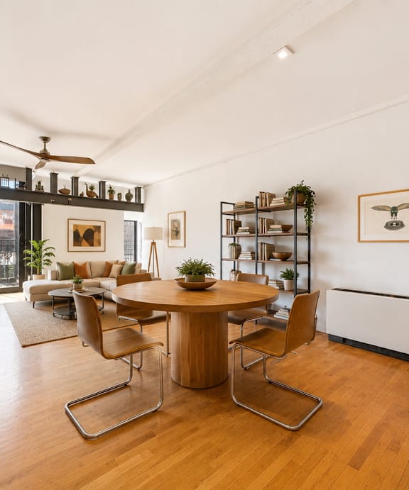 A room with wooden flooring and a ceiling fan.