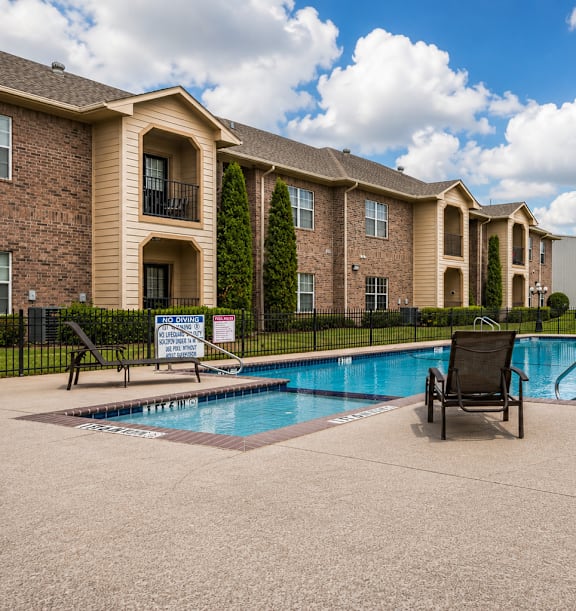 a swimming pool with a chair the corners apartments