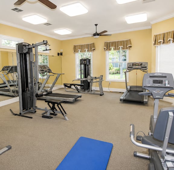 a large fitness room with a lot of exercise equipment