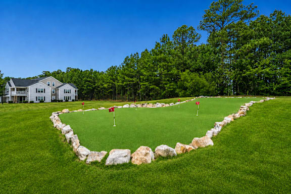 A well-maintained golf course with a flag on the green.